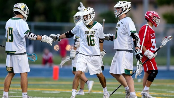 Jupiter’s #16 Riley Linden celebrates his goal against St. Andrew’s with #19 Chris Radice and #0 Benno Janssen during the state championships at Boca Raton High School on May 11, 2018. (Richard Graulich / The Palm Beach Post)