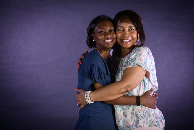 Carolyn Winfrey, right, shares a hug with her daughter, Brenda Winfrey-Knox. [Andrew Craft/The Fayetteville Observer]