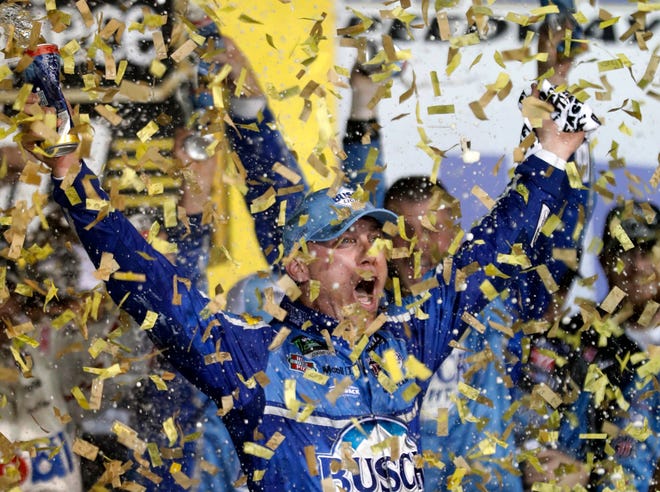Kevin Harvick is covered in confetti as he celebrates winning the NASCAR Cup Series auto race at Kansas Speedway in Kansas City, Kan., Saturday, May 12, 2018. (AP Photo/Colin E. Braley)