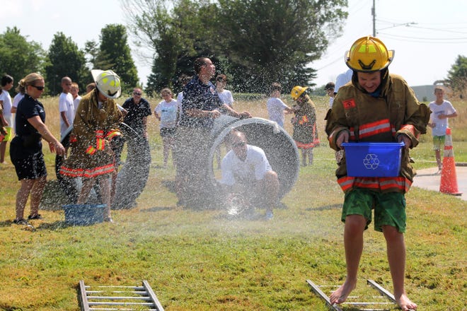 Junior Police Academy students take part in an obstacle course alongside Holland firefighters Wednesday, July 27, 2016. Curtis Wildfong/Sentinel staff