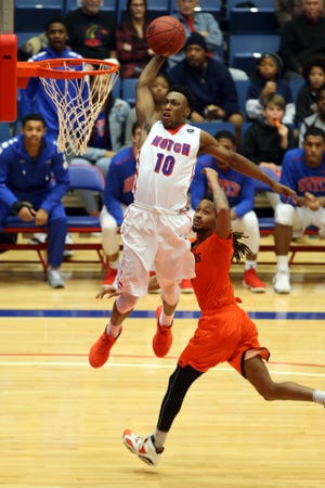 Hutchinson's Devonte Bandoo goes in for a dunk past Neosho's Teven Downing in the second half on Jan. 31, 2016 at the Sports Arena. [Travis Morisse/HutchNews]