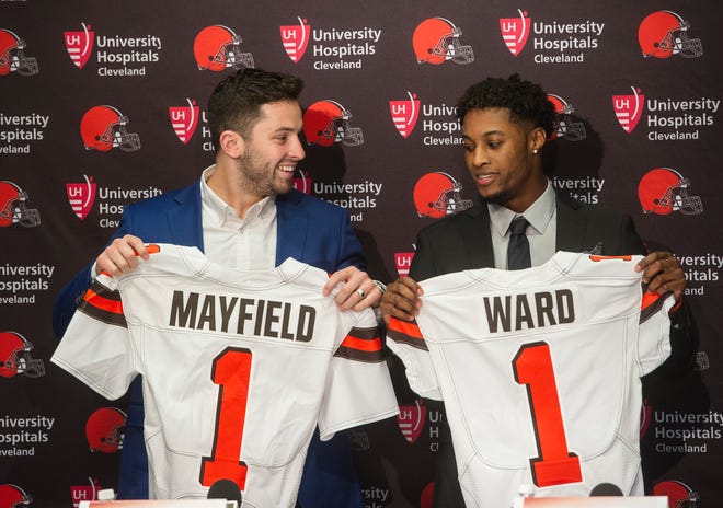 Cleveland Browns first-round draftees Baker Mayfield, left, and Denzel Ward pose after a news conference at the team's headquarters in Berea, Ohio, Friday, April 27, 2018. (AP Photo/Phil Long)