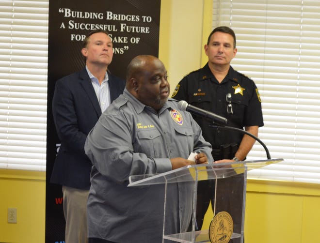 The Rev. John Guns (center), head of Operation Save Our Sons, joined Jacksonville Mayor Lenny Curry (left), Sheriff Mike Williams (right) and others Monday to announce this summer's SPOT (Safe Place for Our Teens) at Johnnie Walker Community Center at 2500 W. 20th St. [Dan Scanlan/Florida Times-Union]