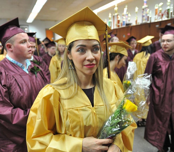 Diana Sugarman holds her bouquet as her class prepares for the Weymouth Evening High School graduation ceremony, Monday, May 14, 2018. Tom Gorman/For The Patriot Ledger