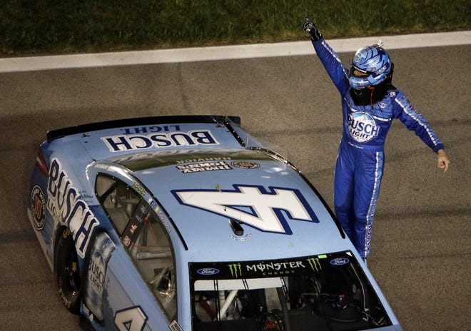 Kevin Harvick (4) celebrates after winning the NASCAR Cup Series auto race at Kansas Speedway on Saturday, May 12, 2018, in Kansas City, Kan. (AP Photo/Charlie Riedel)