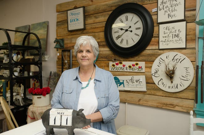 Cindy Harris stands in Magnolias & Ivy at 107 S. Main St., an antique shop she and her daughter, Kelly, took over from Debra Craver in March. [Ben Coley/The Dispatch]