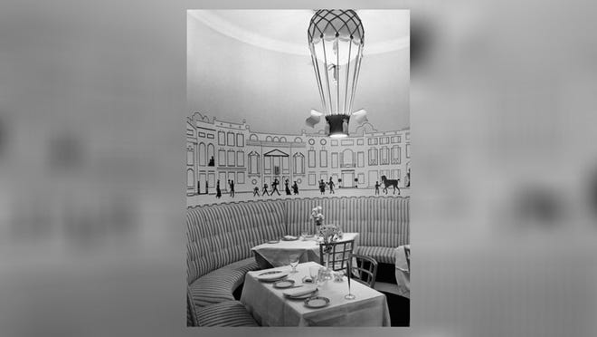 Dorothy Draper was the original decorator for The Carlyle and started the work in 1930. Here, a photo from the period shows a dining room furnished with curved banquettes and a balloon-style lighting fixture. Photo courtesy Dorothy Draper & Co.