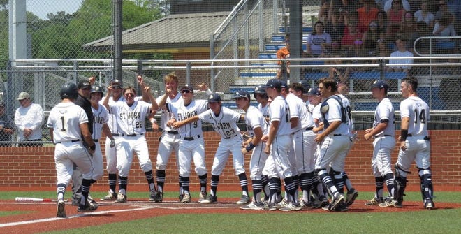 The Eagles celebrate the first score in their semifinal matchup with Houma Christian. St. John won the game, 6-5.