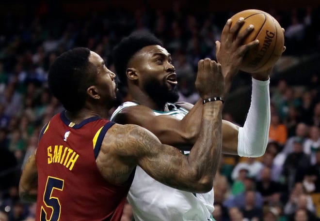 Boston's Jaylen Brown drives on Cleveland's JR Smith in the second half on Tuesday night.
