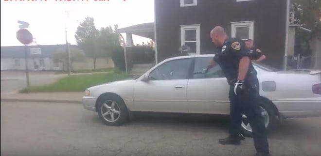 Canton police surround the car Ronald D. Wagner II was driving before taking him into custody with the help of a police dog. (Canton police video)