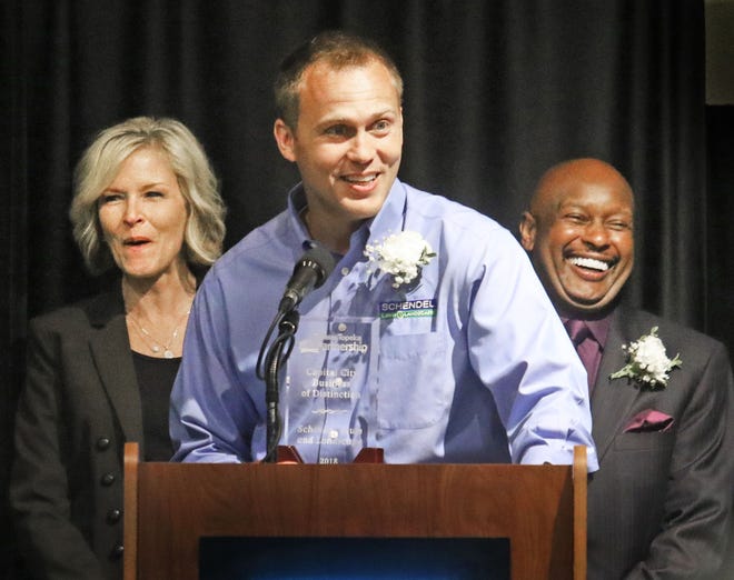 Aaron Jones, managing partner with Schendel Lawn and Landscape, spoke after it was announced the company won the Capital City Business of Distinction award at the 2018 small business awards luncheon Tuesday. Behind Jones were Shawnee County Commissioner Shelly Buhler and Eugene Williams, general manager of KTWU. [Thad Allton/The Capital-Journal]