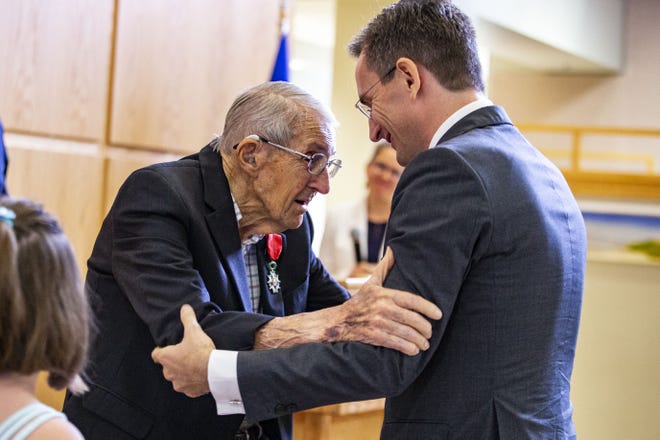 Donald Rothwell, former University of Florida professor, and the Consul General of France Clément Leclerc smile at each other after Leclerc presented the Legion of Honor medal to Rothwell for his service in World War II. 

[Lauren Bacho/Gainesville Sun]