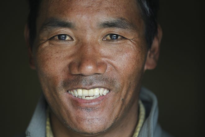 Nepalese veteran Sherpa guide Kami Rita, 48, poses for a photograph at his rented apartment in March in Kathmandu, Nepal. Rita scaled Mount Everest on Wednesday morning for the 22nd time, setting the record for most climbs of the world's highest mountain, officials said. [AP Photo / Niranjan Shrestha, File]