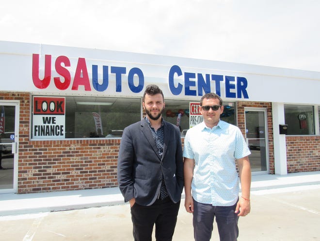Artem Bilous, left, and Igor Coada, right, of USAuto Center, stand outside their new location in Colonial Heights. [Chai Gallahun/progress-index.com]