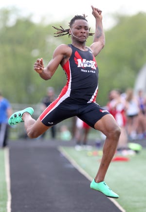 McKinley's Charles Hall competes in the boys long jump during the Division I district track and field meet at Hoover. Hall won his first district long jump title and will compete in next week's regional at Austintown Fitch. (CantonRep.com / Scott Heckel)