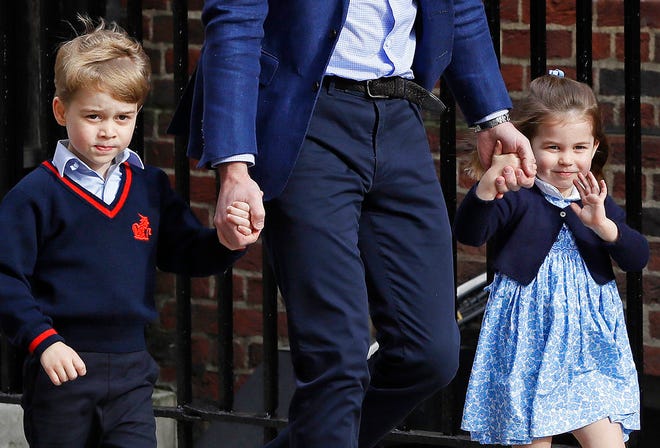 FILE - In this Monday, April 23, 2018 file photo, Britain's Prince William arrives with Prince George and Princess Charlotte at the Lindo wing at St Mary's Hospital in London. Kensington Palace said Wednesday May 16, 2018, that four-year-old George will be a page boy and three-year-old Charlotte will be a bridesmaid at the wedding of Prince Harry and Meghan Markle on Saturday. (AP Photo/Kirsty Wigglesworth, File)