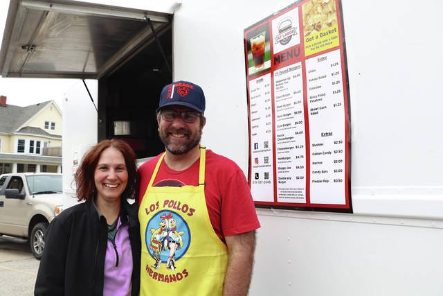 Jason Sampson and his wife Marcia pose for a photo on day one of their food truck journey. The Sampsons opened At-Large Burger Co. this past Saturday in Nevada. Photo by Marlys Barker