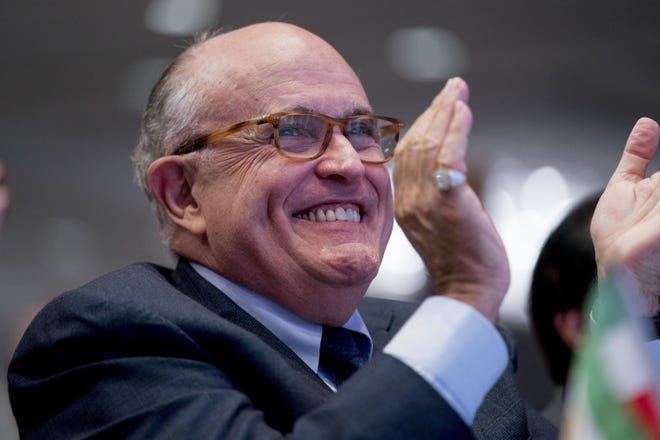 In this May 5, 2018 photo, Rudy Giuliani, an attorney for President Donald Trump, applauds at the Iran Freedom Convention for Human Rights and democracy at the Grand Hyatt in Washington. GiulianiþÄôs decision to join President Donald TrumpþÄôs legal team could backfire on the former New York mayor if potential clients of his international consulting business view him as too erratic and go elsewhere for representation, according to legal experts. (AP Photo/Andrew Harnik)