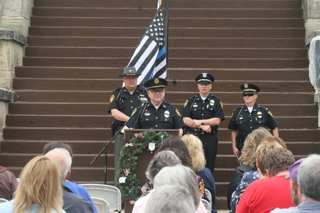 Lt. Eldon Trubee of the Millersburg Police Auxiliary welcomes the crowd to the law enforcement memorial at the Holmes County Courthouse on Friday, commemorating fallen officers in Ohio and across the country.