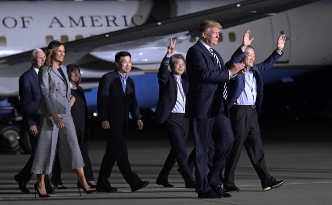 President Donald Trump welcomes, from left, Tony Kim, Kim Hak Song and Kim Dong Chul, the three Americans detained in North Korea for more than a year, as they arrive at Andrews Air Force Base in Maryland on May 10. Walking with Trump is Vice President Mike Pence and first lady Melania Trump. [SUSAN WALSH/THE ASSOCIATED PRESS]