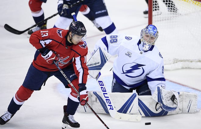 Tampa Bay Lightning goaltender Andrei Vasilevskiy (88) watches the puck next to Washington Capitals left wing Jakub Vrana (13) during the third period of Game 4 of the Eastern Conference finals Thursday in Washington. The Lightning won 4-2. [The Associated Press / Nick Wass]