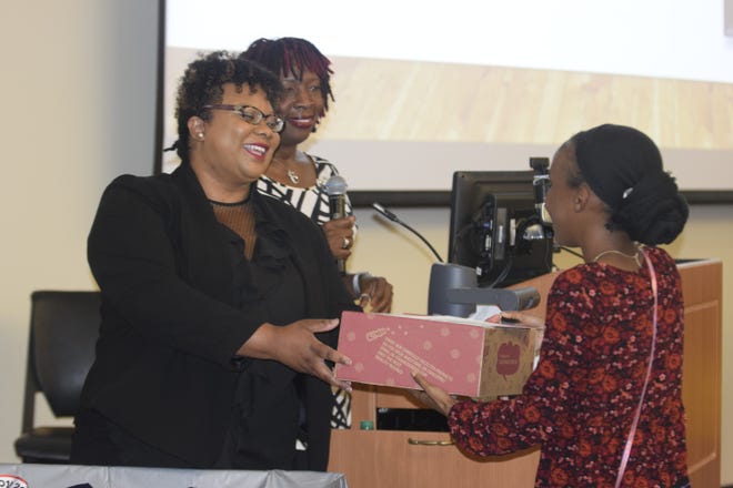 Brielle Bullock receives the Endless Ideas Award as well as a care package from Ebony Hicks. Bullock was one of two seniors who participated in Girls Who Code. (AMANDA KING/STAFF)