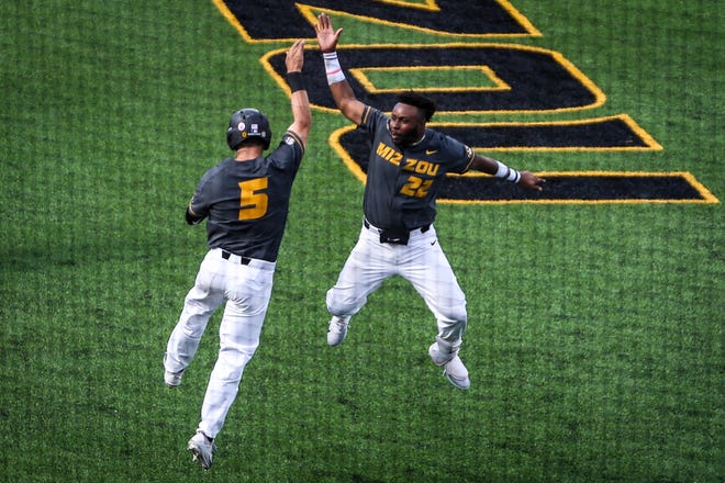 Missouri outfielder Trey Harris (22) celebrates with Missouri catcher Brett Bond (5) after scoring a run during senior day at Taylor Stadium on Saturday. Missouri defeated Tennessee 8-3 and secured the final spot in the SEC Tournament. See a photo gallery from the game at columbiatribune.com. [Hunter Dyke/Tribune]