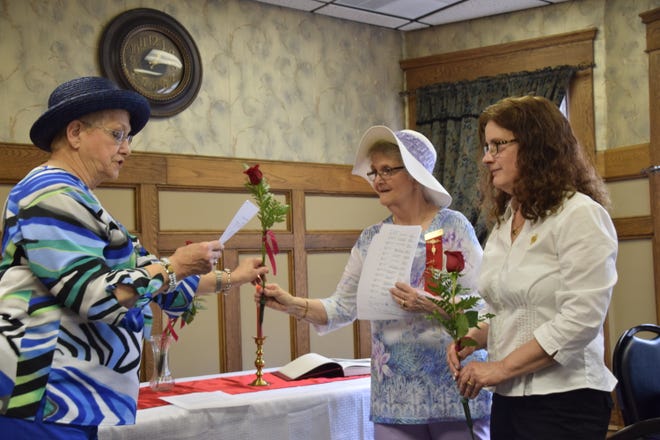 Meier Bauer, left, state president of Delta Kappa Gamma, presents Bonnie Agawa,incoming vice president of the local Beta Iota Chapter with a red rose, symbol of the society. Cathie Lynch, secretary for the 2018-2020 term watches.