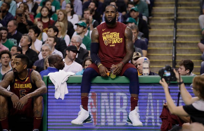 In this Tuesday, May 15, 2018, file photo, Cleveland Cavaliers forward LeBron James sits on the scorer's table during a timeout in the first half in Game 2 of the team's NBA basketball Eastern Conference finals against the Boston Celtics in Boston. James has twice come back from a 2-0 deficit in the NBA playoffs. He’s going to need to do it three times to make the NBA Finals for the eighth straight year, down 2-0 to the Celtics.