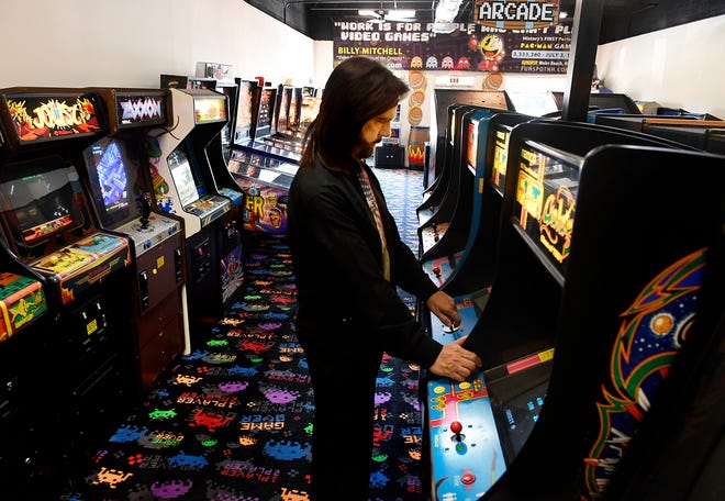 Billy Mitchell, a competitive gamer who lives in Hollywood, plays at Arcade Game Sale in Fort Lauderdale. Mitchell, once declared the Video Game Player of the Century, is now facing the ultimate test of his skills: salvaging his reputation. Twin Galaxies, competitive gaming's governing body, found him guilty of cheating. [Taimy Alvarez/South Florida Sun-Sentinel via AP]