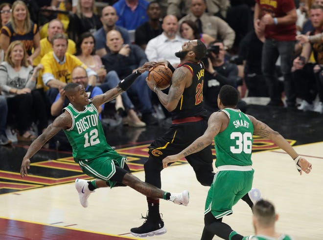 Cleveland's LeBron James drives on Boston's Terry Rozier (12) as Marcus Smart follows in the first half on Saturday night.