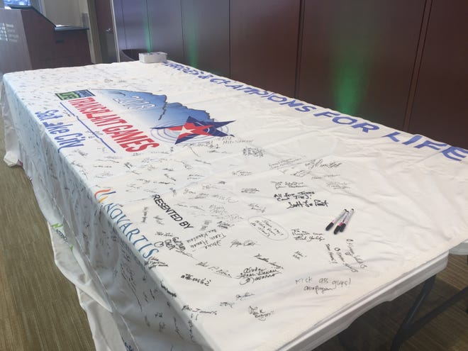 A transplant flag is ready for signing Saturday at the Memorial Center for Learning and Innovation. The flag will fly over Salt Lake City, Utah, during the Transplant Games of America, Aug. 2-7. [Tamara Browning/The State Journal-Register]