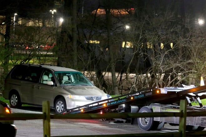 In this April 10 photo, a minivan is removed from the parking lot near the Seven Hills School campus in Cincinnati. (Cara Owsley/The Cincinnati Enquirer via AP, File)