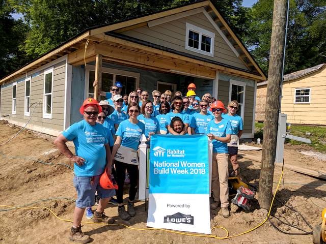 Volunteers for the annual Habitat for Humanity Women Build Week pose in front of a new house built for local Columbia woman Vanesia Brown and her two children. (Photo submitted by Jennee Galland)