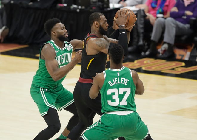 Boston Celtics' Semi Ojeleye (37) and Boston Celtics' Jaylen Brown, left, double-team Cleveland Cavaliers' LeBron James, center, in the second half of Game 3 of the NBA basketball Eastern Conference finals, Saturday, May 19, 2018, in Cleveland. (AP Photo/Tony Dejak)