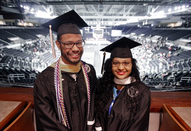 Ron and Nicole De La Rosa Ramirez, siblings born in the Dominican Republic, before Providence College's graduation ceremony at the Dunkin' Donuts Center on Sunday. [The Providence Journal / Glenn Osmundson]