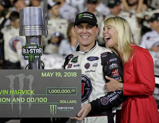 Kevin Harvick celebrates in Victory Lane with his wife, DeLana Harvick, after winning the All-Star race on Saturday. [The Associated Press]