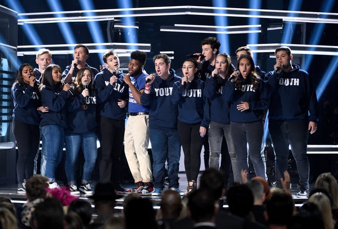 Khalid, seventh from left, and Shawn Mendes, fifth from right, perform "Youth" with the Stoneman Douglas choir, of the Marjory Stoneman Douglas High School, at the Billboard Music Awards at the MGM Grand Garden Arena on Sunday in Las Vegas.