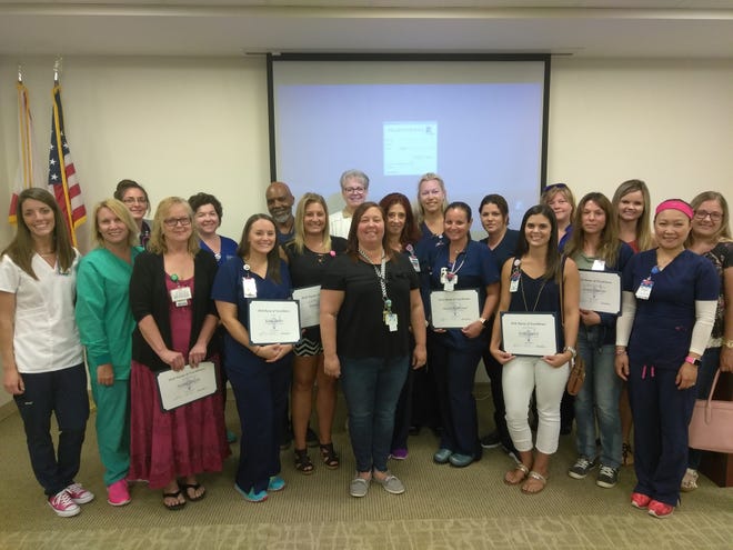 Halifax Health recognized outstanding members of its nursing team during the 2018 Clinical Excellence Awards Ceremony, May 10 at Halifax Health Medical Center of Daytona Beach. During the event, recipients of Halifax HealthþÄôs 2018 scholarships were announced, as well as the winners of the Rookie of the Year Award, which is given to newly hired nurses. Each care unitþÄôs recipient of the 2018 Nurse of Excellence Award also was recognized. Awarded annually, the Nurse of Excellence Award honors outstanding Halifax Health nursing professionals for their dedication to quality patient care. Pictured are Halifax HealthþÄôs 2018 Nurse of Excellence Award winners with Halifax Health Chief Nursing Officer Catherine Luchsinger (back row, center). [Photo provided]