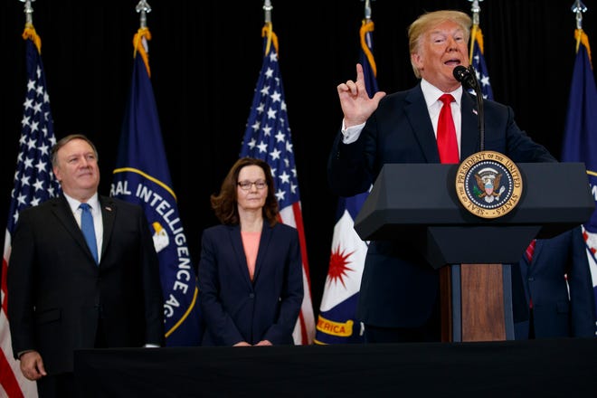 Secretary of State Mike Pompeo, left, and incoming Central Intelligence Agency director Gina Haspel, center, listen to President Donald Trump speak during a swearing-in ceremony at CIA Headquarters, Monday, May 21, 2018, in Langley, Va. (AP Photo/Evan Vucci)