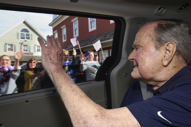 Former President George H.W. Bush waves to supporters as his motorcade arrives in Kennebunkport, Maine, on Sunday, May 20, 2018. [Evan Sisley via AP]