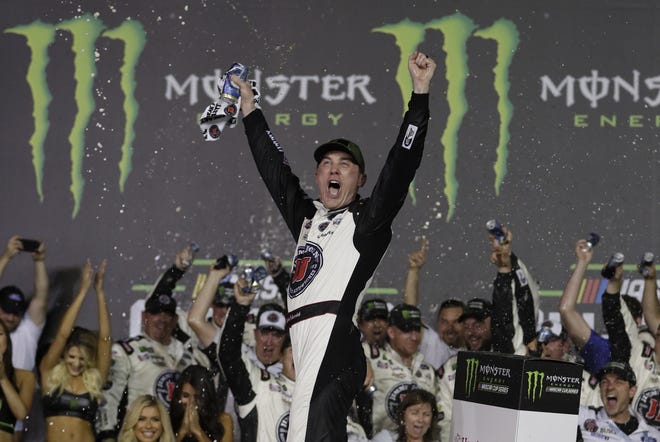 Kevin Harvick celebrates in Victory Lane after winning the NASCAR All-Star race at Charlotte Motor Speedway in Concord, N.C. on Saturday. [AP PHOTO/CHUCK BURTON]