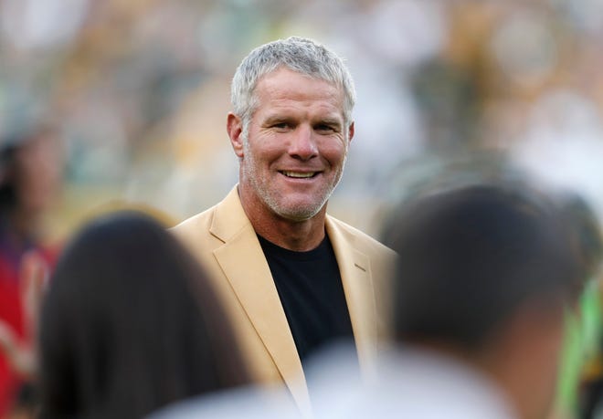 In this Oct. 16, 2016, file photo, Hall of Fame quarterback Brett Favre is shown during a halftime ceremony of an NFL football game against the Dallas Cowboys, in Green Bay, Wis. Favre says he made three trips to rehabilitation centers to fight his dependence on painkillers and alcohol. Sports Illustrated reports that Favre says he took as many as 14 Vicodin at one time during his MVP season of 1995. AP Photo/Matt Ludtke, File)