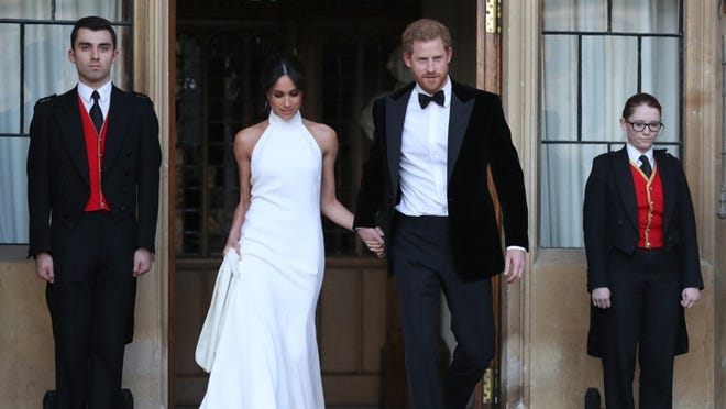 Duchess of Sussex and Prince Harry, Duke of Sussex wave as they leave Windsor Castle after their wedding to attend an evening reception on May 19, 2018 in Windsor, England. (Photo by Steve Parsons - WPA Pool/Getty Images)