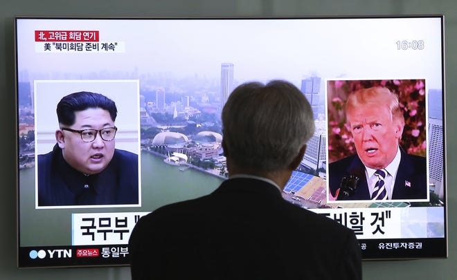 A man watches a TV screen showing file footage of U.S. President Donald Trump, right, and North Korean leader Kim Jong Un during a news program at the Seoul Railway Station in Seoul, South Korea, Wednesday, May 16, 2018. North Korea's breaking off a high-level meeting with South Korea and threatening to scrap next month's historic summit with President Trump over allied military drills is seen as a move by Kim to gain leverage and establish that he's entering the crucial nuclear negotiations from a position of strength. Washington and Seoul, which have no intentions to overpay for whatever Kim brings to the table, say international sanctions forced Kim into talks after a flurry of weapons tests. (AP Photo/Ahn Young-joon)