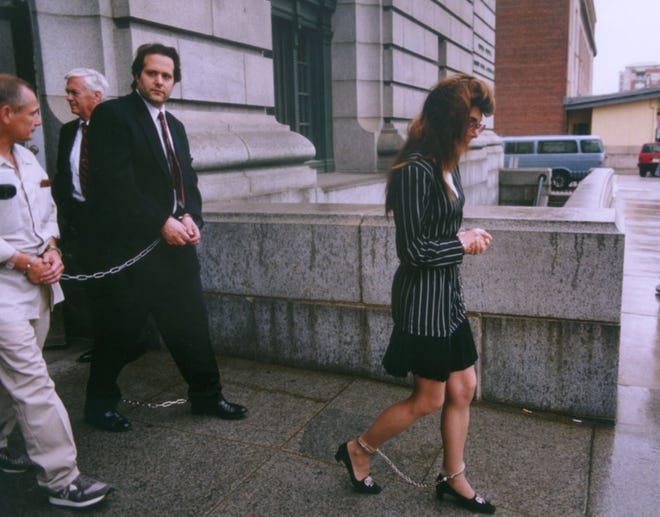 Stephen and Donna Saccoccia in 1992 leave the Providence federal courthouse in leg irons. [The Providence Journal / Frieda Squires]