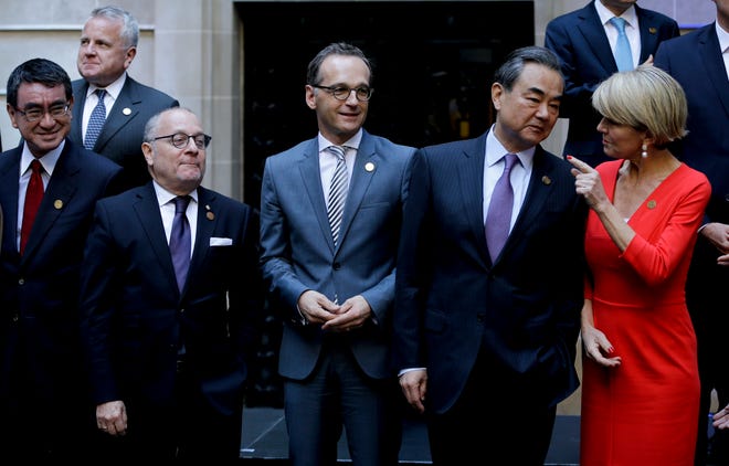 Argentina's Foreign Secretary Jorge Faurie, second from left, Germany's Foreign Minister Heiko Maas, third from left, China's Foreign Minister Wang Yi, second from right, and Australia's Foreign Affairs Minister Julie Bishop talk before the group picture during the G20 foreign ministers meeting at San Martin Palace in Buenos Aires, Argentina, Monday, May 21, 2018. (AP Photo/Natacha Pisarenko)