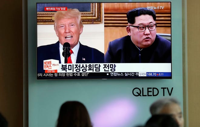 FILE - In this May 11, 2018, file photo, people watch a TV screen showing file footage of U.S. President Donald Trump, left, and North Korean leader Kim Jong Un, right, during a news program at the Seoul Railway Station in Seoul, South Korea. Weeks from his North Korea summit, President Donald Trump is staring down a dealmaker’s worst nightmare: overpromising and under-delivering.(AP Photo/Lee Jin-man, File)