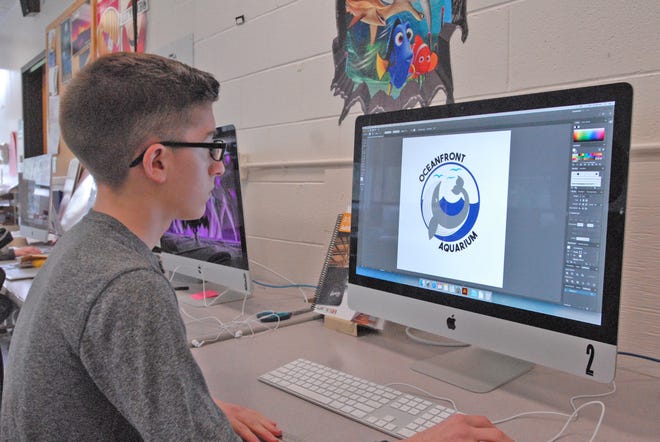 Bristol-Plymouth Regional Technical School sophomore Brandon Levesque of Bridgewater won first place in the “embroidery, three colors or less” category for his Oceanfront Aquarium sweatshirt logo design at the Printing Industries of New England (PINE) awards at Mechanics Hall in Worcester on April 10. Brandon pulls up his winning design on the computer in the graphic design shop at the school on May 7. Taunton Gazette Mike Gay