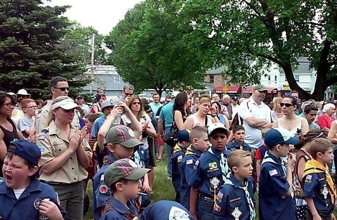 Scouts at a past Memorial Day observance at North Common; this year's Memorial Day observance takes pace at the Town Common in the town center. [Wicked Local File Photo]